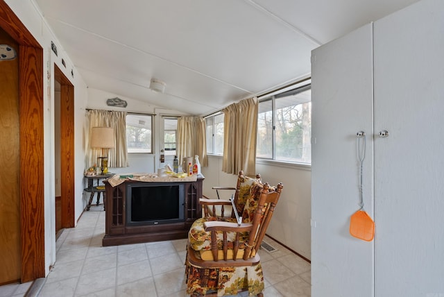 sitting room featuring vaulted ceiling