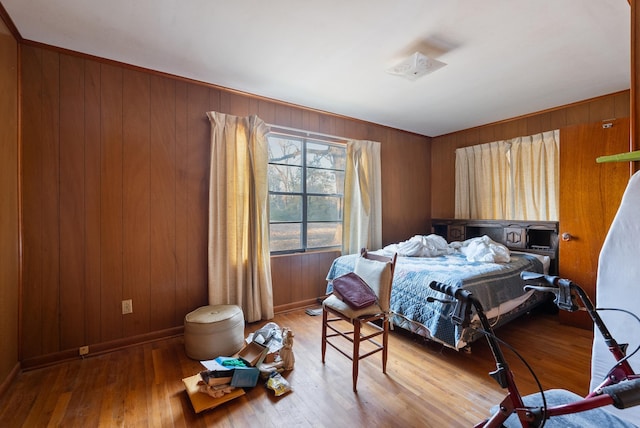 bedroom with wood-type flooring and wooden walls