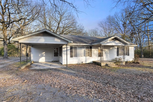 ranch-style home featuring a carport