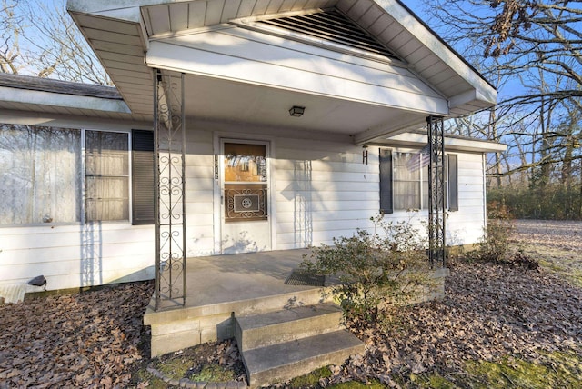 view of exterior entry with covered porch