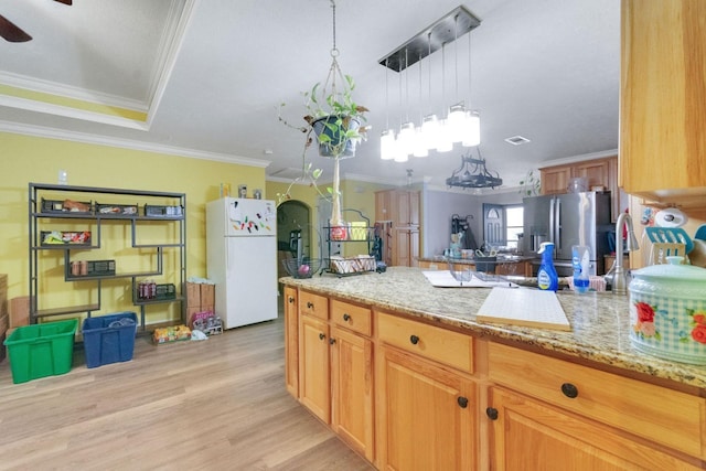 kitchen featuring crown molding, light stone countertops, stainless steel refrigerator with ice dispenser, and white refrigerator