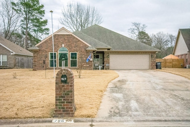 view of front of house with a garage and central air condition unit