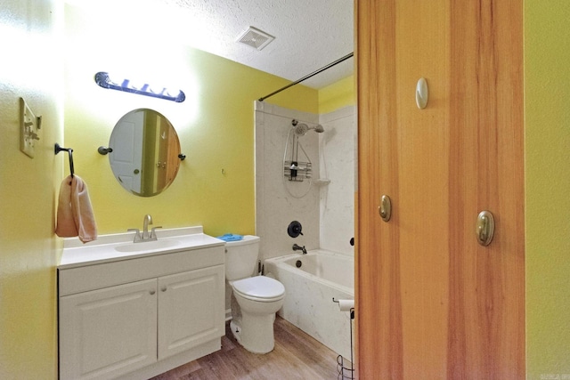 full bathroom with toilet, bathing tub / shower combination, wood-type flooring, a textured ceiling, and vanity