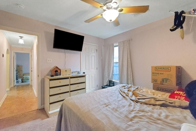 bedroom with light carpet, a closet, and ceiling fan