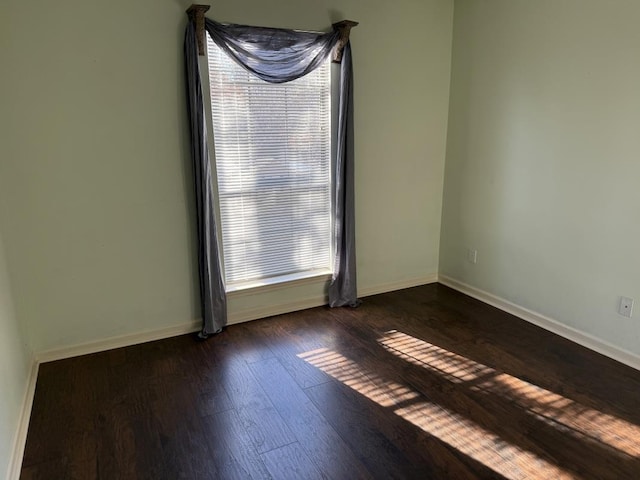 unfurnished room with dark wood-type flooring