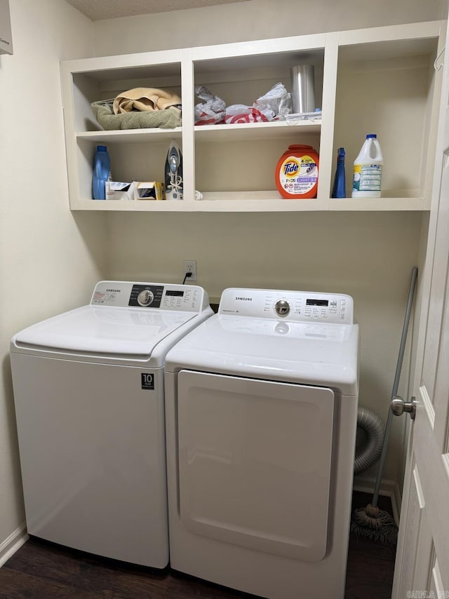 clothes washing area featuring separate washer and dryer and dark hardwood / wood-style floors