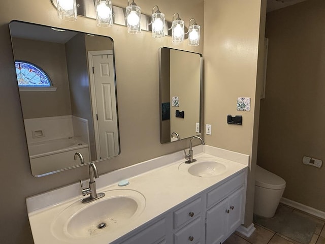 bathroom with vanity, toilet, and tile patterned flooring