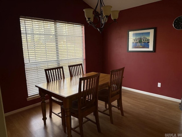 dining room featuring hardwood / wood-style flooring and a chandelier