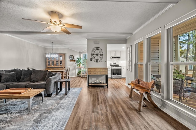 living room featuring crown molding, hardwood / wood-style flooring, ceiling fan with notable chandelier, and a textured ceiling