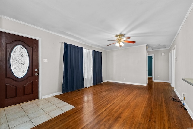 foyer with ornamental molding, light hardwood / wood-style floors, and ceiling fan