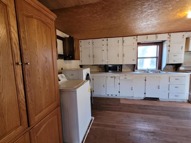 laundry area featuring dark hardwood / wood-style flooring, wood ceiling, washer / dryer, and sink