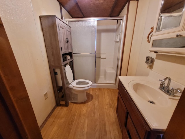 bathroom featuring vanity, hardwood / wood-style floors, toilet, and walk in shower