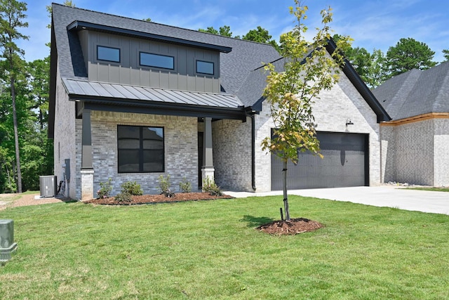 view of front of home with a porch, a garage, central AC unit, and a front yard