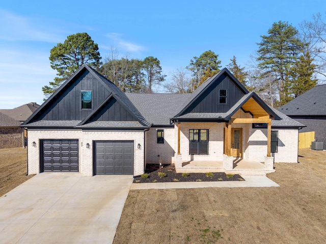 view of front of house featuring a garage, central AC, and a front lawn