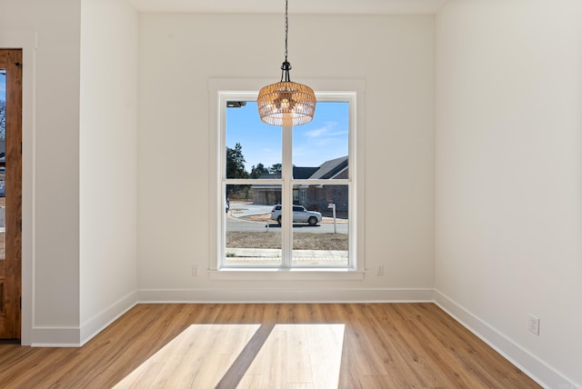 unfurnished dining area featuring hardwood / wood-style flooring