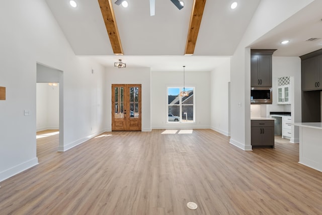 unfurnished living room with french doors, high vaulted ceiling, beam ceiling, and light hardwood / wood-style floors