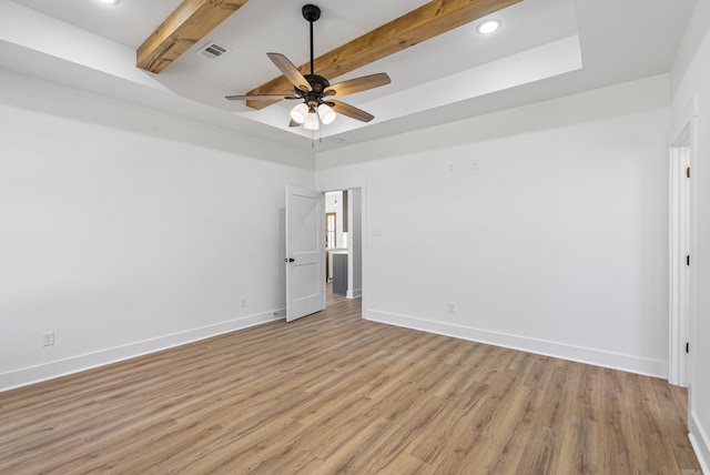 unfurnished room with beamed ceiling, ceiling fan, and light wood-type flooring