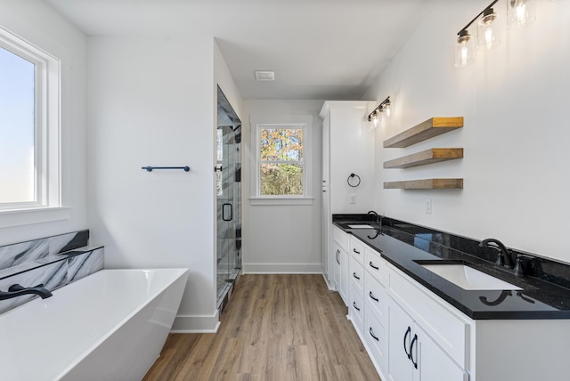 bathroom with vanity, separate shower and tub, and hardwood / wood-style floors