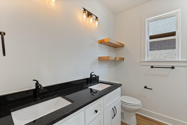 bathroom with vanity, hardwood / wood-style floors, and toilet