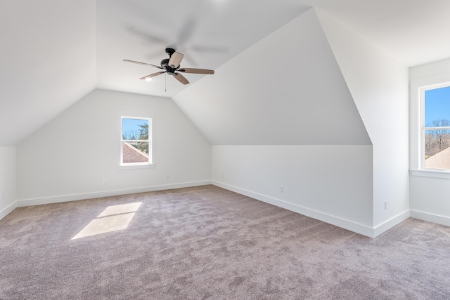 bonus room featuring lofted ceiling, light colored carpet, and ceiling fan