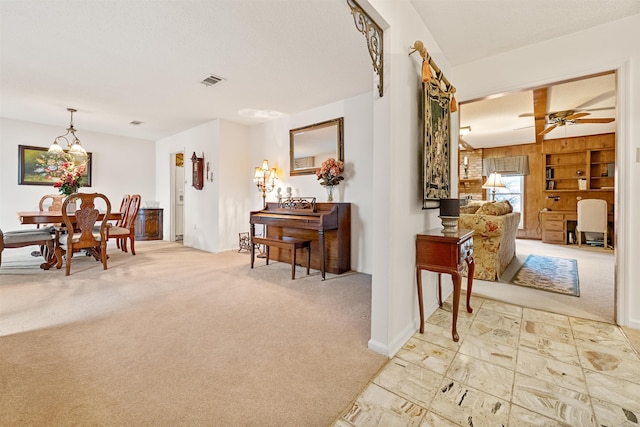 interior space featuring light colored carpet and ceiling fan