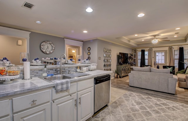 kitchen with sink, white cabinetry, crown molding, stainless steel dishwasher, and ceiling fan