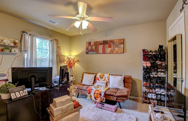 carpeted living room featuring ceiling fan