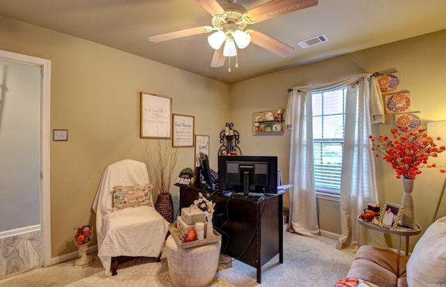 carpeted office space with ceiling fan