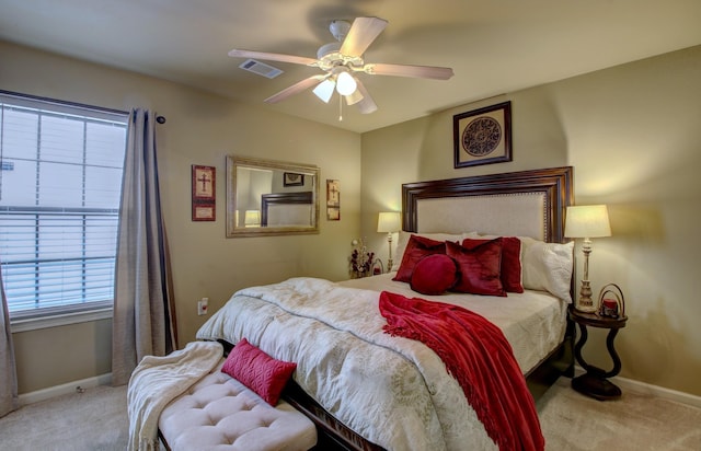 bedroom featuring light colored carpet and ceiling fan