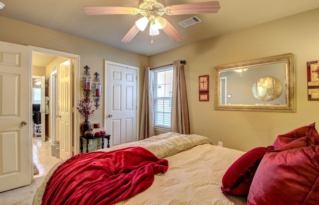 tiled bedroom with ceiling fan