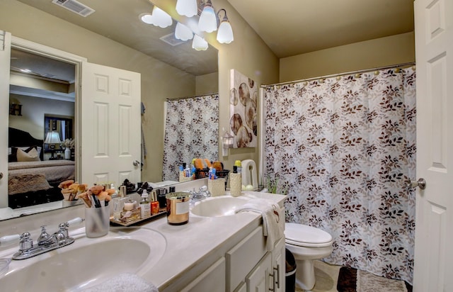 bathroom featuring a shower with curtain, vanity, an inviting chandelier, and toilet