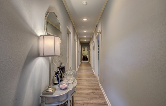 corridor with crown molding and light wood-type flooring