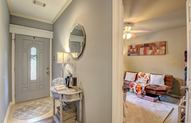 entryway with ornamental molding and ceiling fan