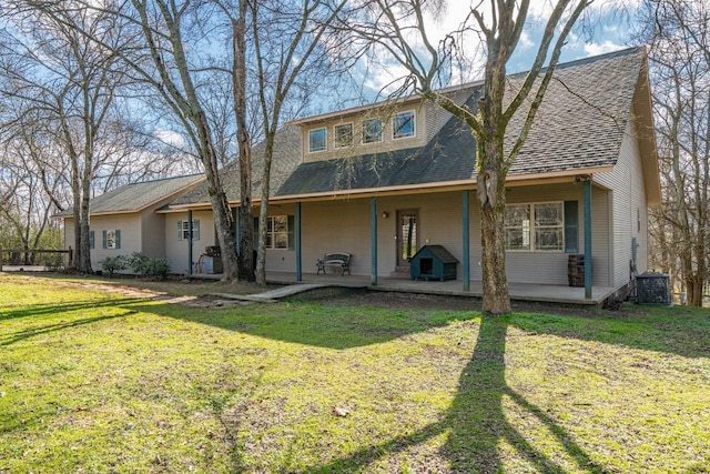 back of property with a yard and a patio