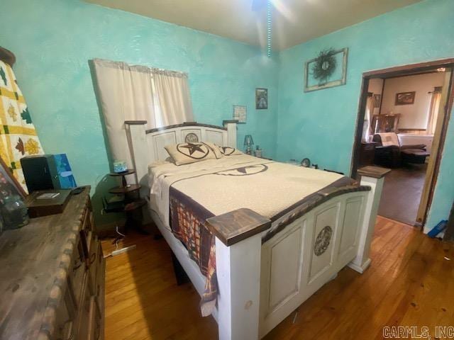 205 S Main, Okolona, AR 71962 - bedroom featuring hardwood / wood-style floors