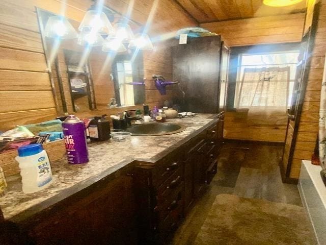 205 S Main, Okolona, AR 71962 - bathroom with wooden ceiling, vanity, a bathtub, and wood walls