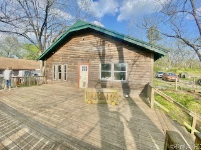 rear view of property featuring a wooden deck