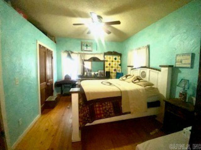 205 S Main, Okolona, AR 71962 - bedroom featuring hardwood / wood-style floors and ceiling fan