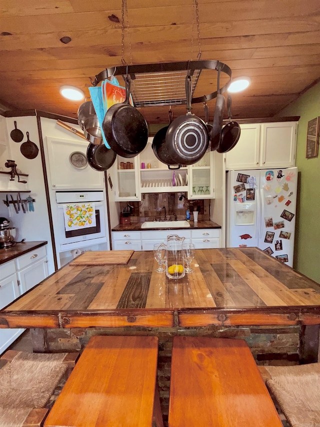 205 S Main, Okolona, AR 71962 - kitchen featuring white cabinetry, white appliances, sink, and wooden ceiling