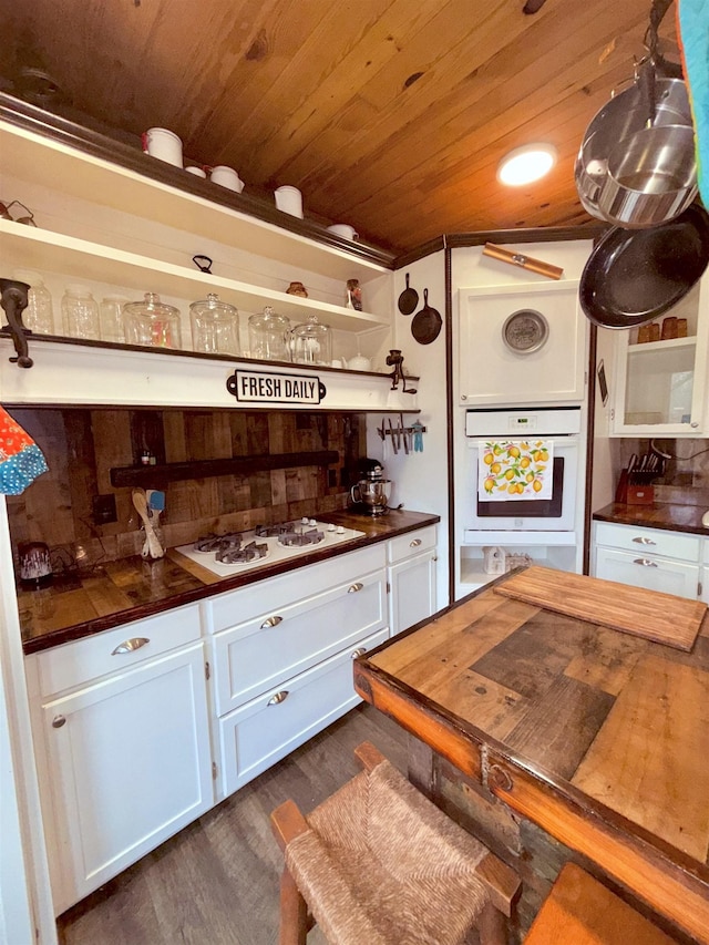 205 S Main, Okolona, AR 71962 - kitchen featuring white cabinetry, white appliances, dark wood-type flooring, and wooden ceiling