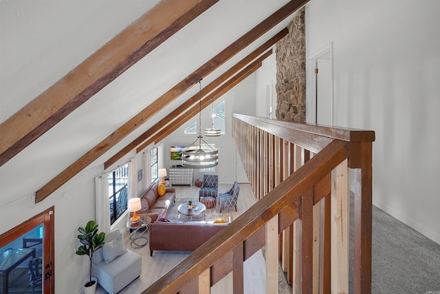 hall featuring light carpet and vaulted ceiling with beams