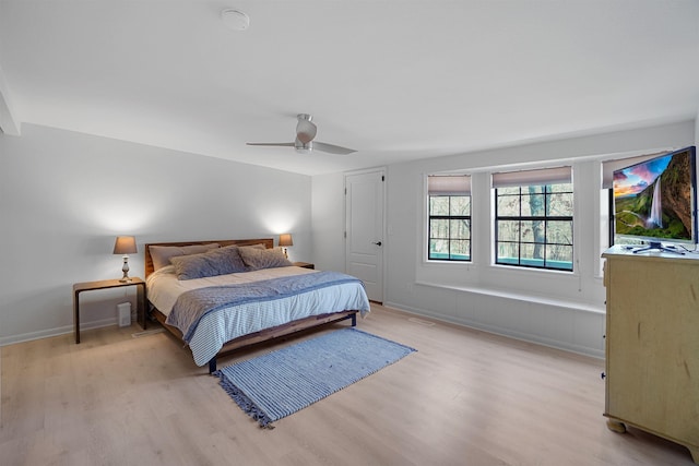 bedroom featuring ceiling fan, a closet, and light hardwood / wood-style flooring