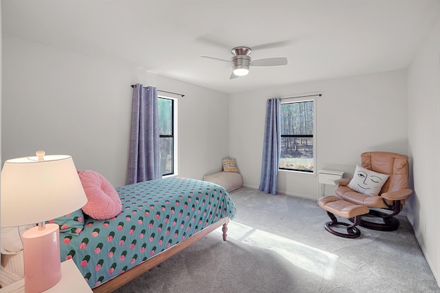 bedroom with ceiling fan, carpet, and multiple windows