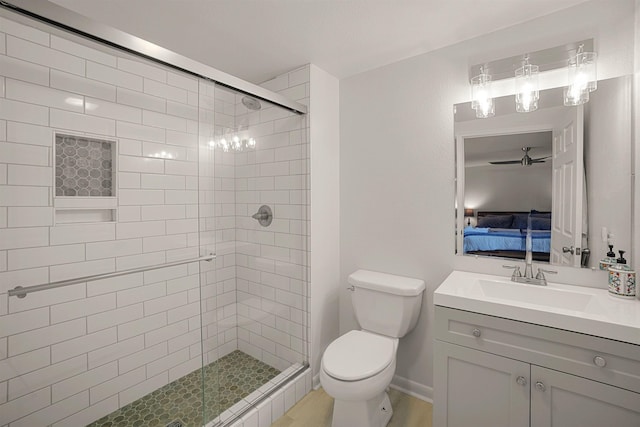 bathroom featuring vanity, ceiling fan, toilet, and walk in shower