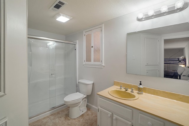 bathroom featuring tile patterned floors, toilet, an enclosed shower, a textured ceiling, and vanity