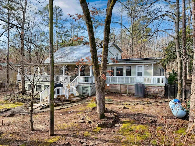 view of front facade with central AC and covered porch