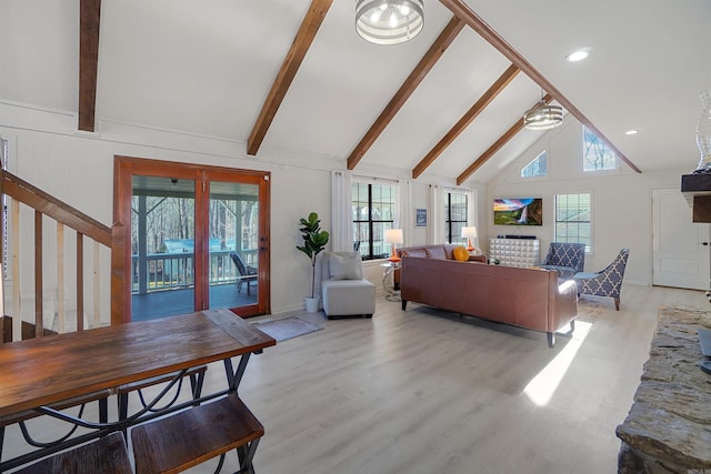 living room featuring beamed ceiling, high vaulted ceiling, and light wood-type flooring