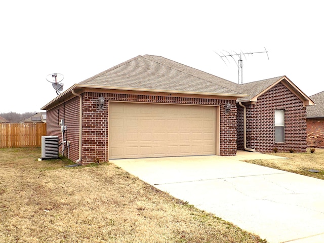 single story home with a garage, central AC, and a front yard