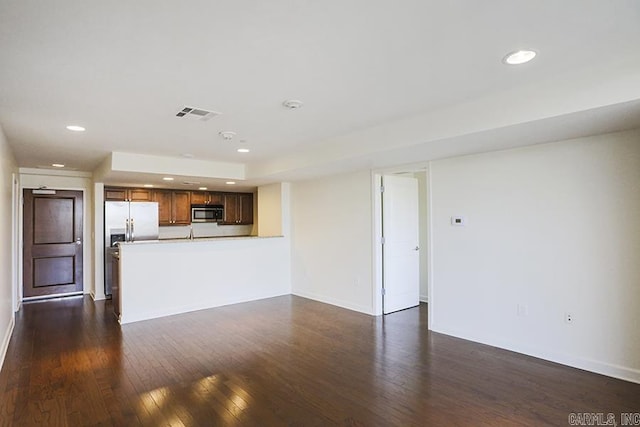 unfurnished living room featuring dark wood-type flooring