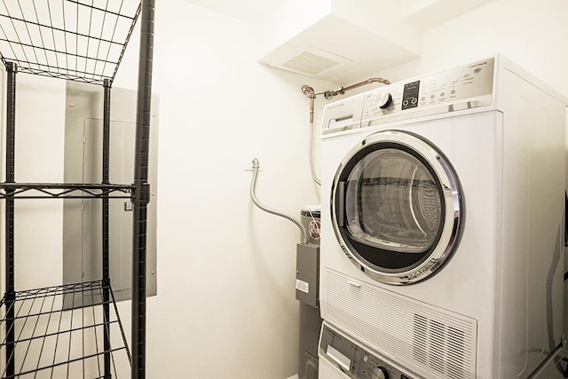 laundry room featuring stacked washer and clothes dryer